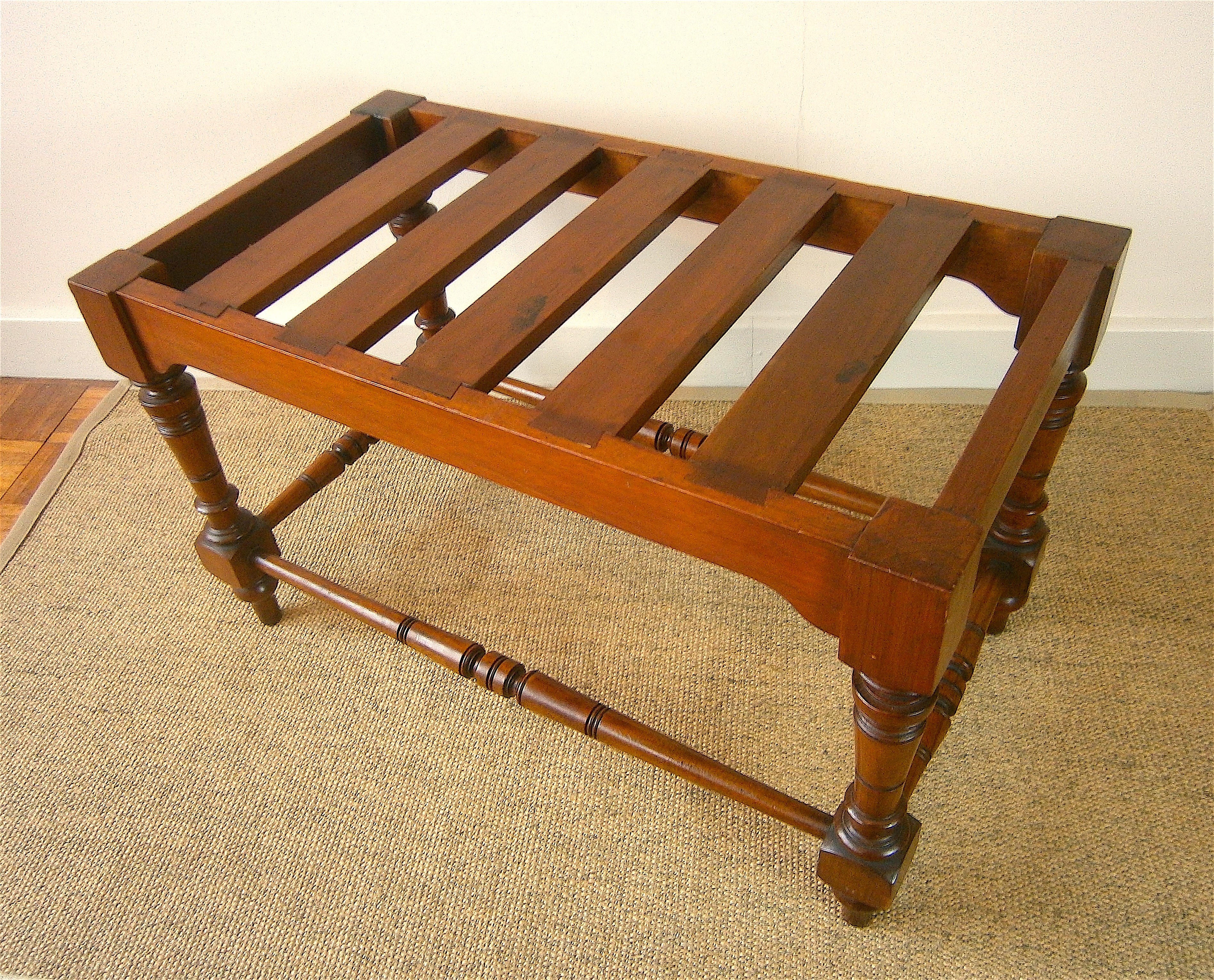 A late Victorian aesthetic movement walnut luggage stand, length 69cm, depth 38cm, height 41cm